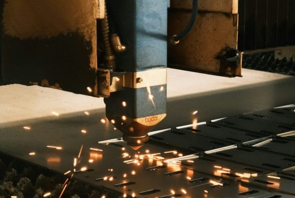 A machine cutting a piece of metal with sparks
